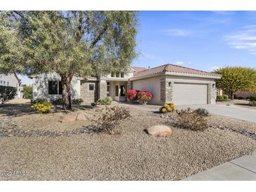 Single-story home with stone accents and desert landscaping at 16310 W Boulder Dr, Surprise, AZ 85374