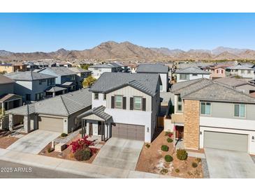 Aerial view of two-story house with gray exterior, landscaping, and mountain backdrop at 20838 W Granada Rd, Buckeye, AZ 85396