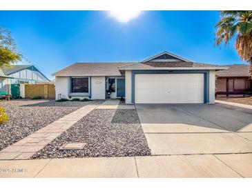 Single-story home with a two-car garage and a well-maintained front yard at 3235 W Irma Ln, Phoenix, AZ 85027