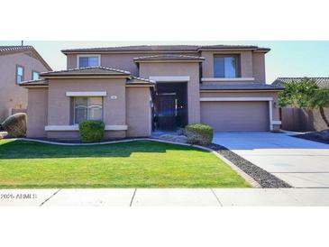 Two-story house with a landscaped lawn and attached garage at 3267 E Maplewood St, Gilbert, AZ 85297