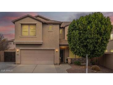 Two-story house with a large garage and mature landscaping at 4627 S Grenoble Cir, Mesa, AZ 85212