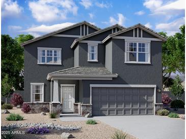 Two-story home with gray exterior, stone accents, and a two-car garage at 47665 W Cansados Rd, Maricopa, AZ 85139