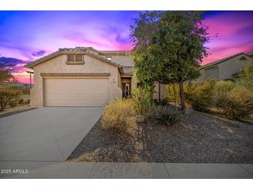 One-story house with a two-car garage and desert landscaping at 5211 W Maldonado Rd, Laveen, AZ 85339