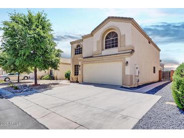 Two-story house with a large garage and well-maintained landscaping at 5725 E Good Pasture Ln, Florence, AZ 85132