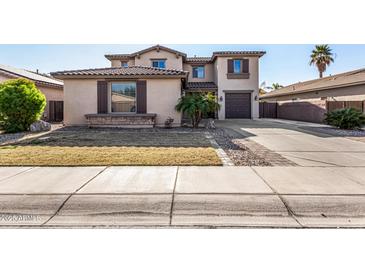 Two-story house with a large driveway and landscaped front yard at 581 W Reeves Ave, San Tan Valley, AZ 85140