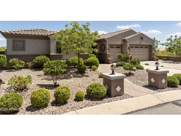 Single-story home with landscaped front yard, two-car garage, and desert landscaping at 11175 N 121St Way, Scottsdale, AZ 85259