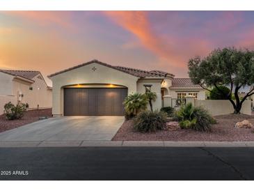 Charming single-story home featuring a tile roof, desert landscaping, and a spacious attached two-car garage at 12942 W Sola Dr, Sun City West, AZ 85375