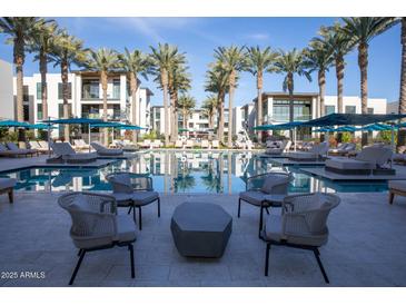 Relaxing resort-style pool with lounge chairs and palms at 6587 N Palmeraie Blvd # 2017, Paradise Valley, AZ 85253