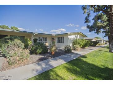 Attractive exterior of a single-story home with well-maintained landscaping and walkway at 10533 W Wheatridge Dr, Sun City, AZ 85373