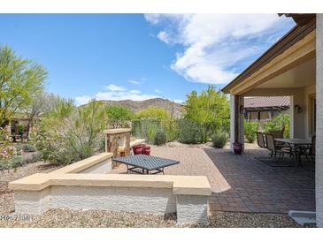 Backyard patio with fire pit and seating area at 17510 W Glenhaven Dr, Goodyear, AZ 85338