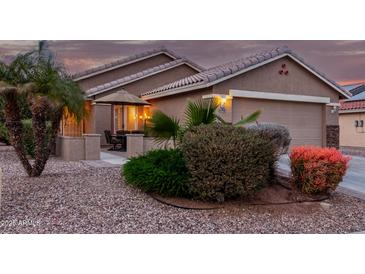 Attractive single-story home with landscaped yard and inviting front patio at 23166 W Shadow Dr, Buckeye, AZ 85326