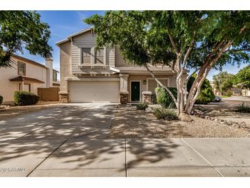 Two-story house with a landscaped front yard and a two-car garage at 6962 W Glenn Dr, Glendale, AZ 85303