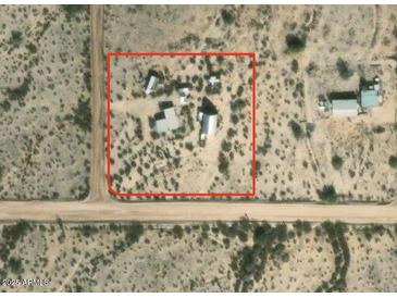 Aerial view of a property with multiple structures on a large lot at 735 S Ruby Rd, Maricopa, AZ 85139