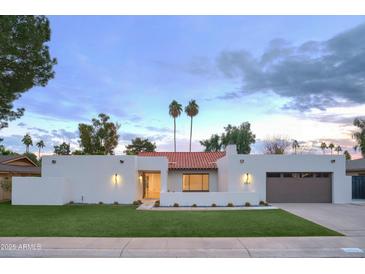 Stunning mid-century modern home with a beautifully landscaped front yard at 8709 E Irish Hunter Trl, Scottsdale, AZ 85258