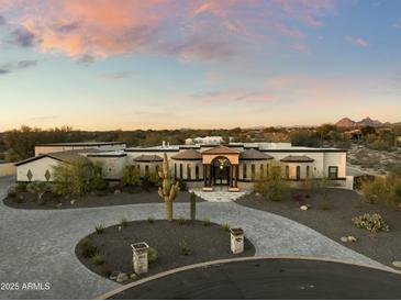 Stunning desert home with circular driveway, landscaped yard, and mountain views at 8802 E Rimrock Dr, Scottsdale, AZ 85255