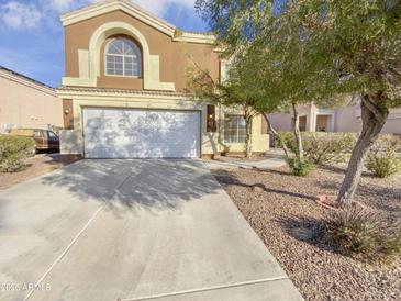 Two-story house with a white garage door and landscaping at 11436 W Austin Thomas Dr, Surprise, AZ 85378