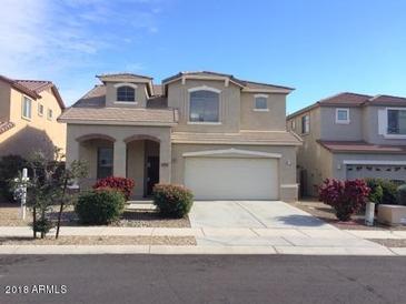 Two-story house with attached garage and landscaping at 14737 N 174Th Dr, Surprise, AZ 85388