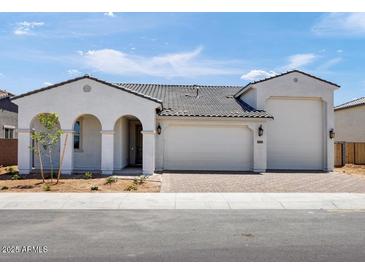 Charming single-Gathering home with a three car garage, covered entry and low maintenance front yard at 17815 W Denton Ave, Litchfield Park, AZ 85340