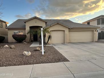 Single-story home featuring a low-maintenance desert landscape and an attached two-car garage at 861 E Toledo St, Gilbert, AZ 85295