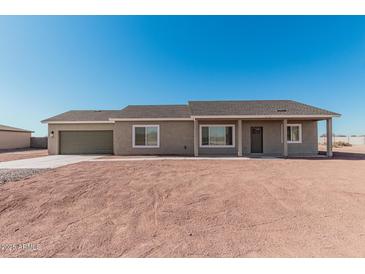 Single-story house with a neutral color scheme and a two-car garage at 3710 N Algodon Dr, Eloy, AZ 85131