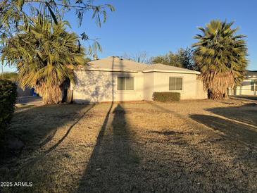 Ranch-style home with mature palm trees and a spacious yard at 4400 N 20Th St, Phoenix, AZ 85016