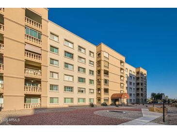 Exterior view of a large apartment building with landscaped grounds at 7960 E Camelback Rd # 609, Scottsdale, AZ 85251