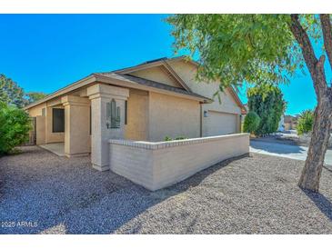 Single-story home with desert landscaping, and a two-car garage at 10405 N 65Th Dr, Glendale, AZ 85302