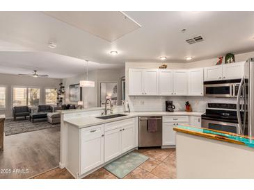 Modern kitchen with white cabinets, stainless steel appliances, and quartz countertops at 14000 N 94Th St # 1134, Scottsdale, AZ 85260