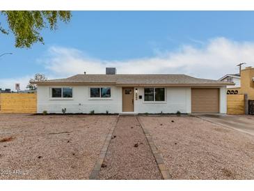 Updated single-story home with new paint, landscaping, and a two-car garage at 1603 W Alcott St, Mesa, AZ 85201