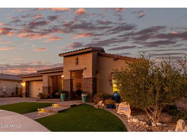 Beautiful desert home with landscaped yard, large driveway and three-car garage at 21122 W Edgemont Ave, Buckeye, AZ 85396