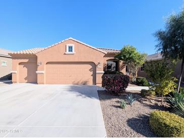 Single-story house with a two-car garage and desert landscaping at 21209 N 40Th Ave, Glendale, AZ 85308