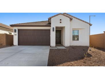 Single-story home with brown garage door and neutral exterior at 23445 W Fulton St, Buckeye, AZ 85326