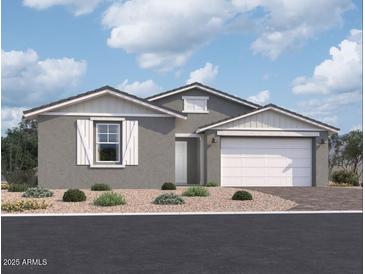 One-story home with gray siding, white garage door, and landscaping at 5510 W Paseo Way, Laveen, AZ 85339