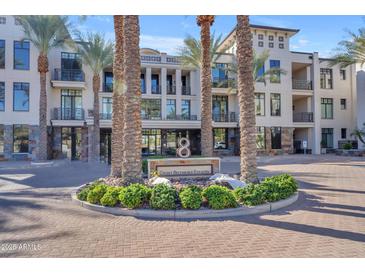 Eight Biltmore Estates building exterior, featuring palm trees and a circular driveway at 8 E Biltmore Est # 117, Phoenix, AZ 85016