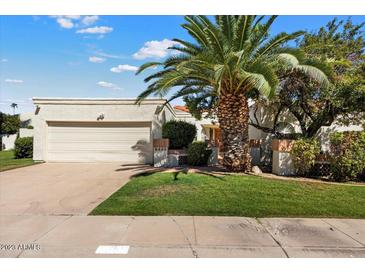 Single-story home with attached garage and lush landscaping at 8466 E San Benito Dr, Scottsdale, AZ 85258