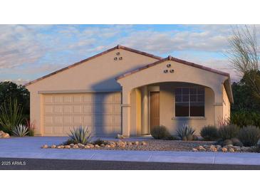 Single-story home with Spanish-style architecture, two-car garage, and desert landscaping at 16768 W Hope Dr, Surprise, AZ 85388