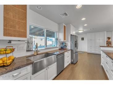 Modern kitchen features stainless steel appliances and granite countertops at 222 E Saint John Rd, Phoenix, AZ 85022