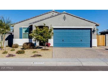 Single-story home with a blue garage door and landscaped front yard at 22432 W Kimberly Dr, Buckeye, AZ 85326