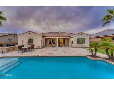 Beautiful home with a large patio, pool, and spacious backyard at 32159 N 127Th Dr, Peoria, AZ 85383