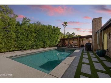 Inviting backyard pool with a spacious patio and pergola at 14415 N 62Nd St, Scottsdale, AZ 85254