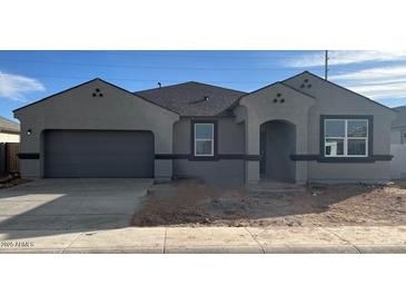 Charming single-story home featuring a two-car garage and low maintenance desert landscaping at 1561 E Mason Dr, Casa Grande, AZ 85122