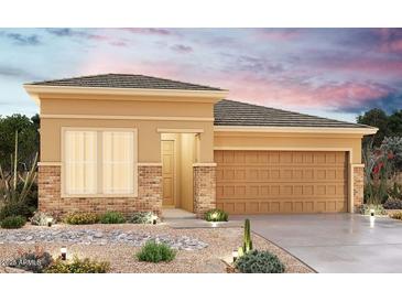 Tan one-story house with brick accents and a two-car garage, desert landscaping at 17378 W Bloomfield Rd, Surprise, AZ 85388