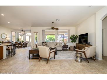 Spacious living room with tile floors and views of backyard at 17824 W Addie Ln, Surprise, AZ 85374