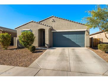 Single-story home with a two-car garage and desert landscaping at 34210 N Beeblossom Trl, San Tan Valley, AZ 85144