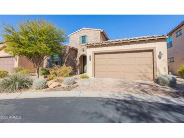 Two story home with tan siding, landscaping and garage at 40 Almarte Cir, Carefree, AZ 85377