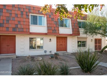 Updated two-story townhome with modern exterior and landscaping at 8375 E Indian School Rd, Scottsdale, AZ 85251