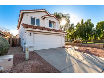 Two-story house with a white exterior, attached garage, and landscaping at 1203 E Muriel Dr, Phoenix, AZ 85022