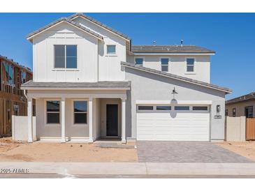 Charming two-story home featuring a white exterior, a two-car garage and a neatly paved driveway at 1350 E Prescott St, Gilbert, AZ 85298