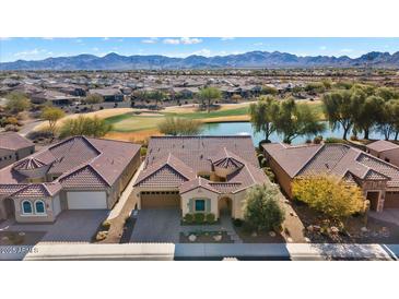Aerial view of home with stunning mountain views and golf course location at 26573 W Abraham Ln, Buckeye, AZ 85396
