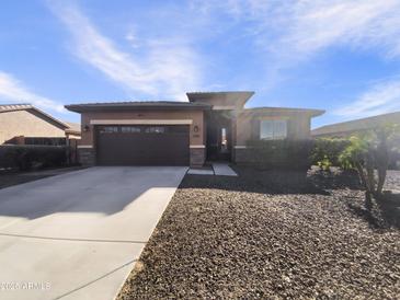 Single-story home with a two-car garage and desert landscaping at 37803 W La Paz St, Maricopa, AZ 85138